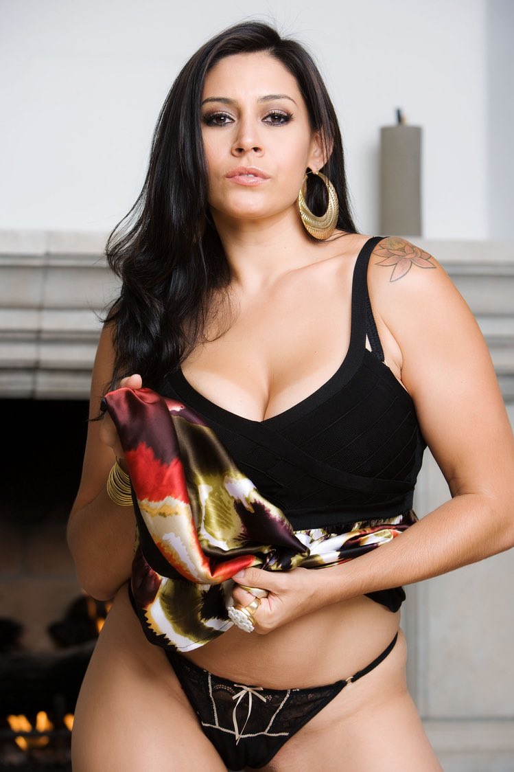 A sophisticated portrait of AVN Hall of Famer Raylene featuring her dark brown hair and brown eyes, reflecting her status as a premier adult icon and professional realtor in 2026.